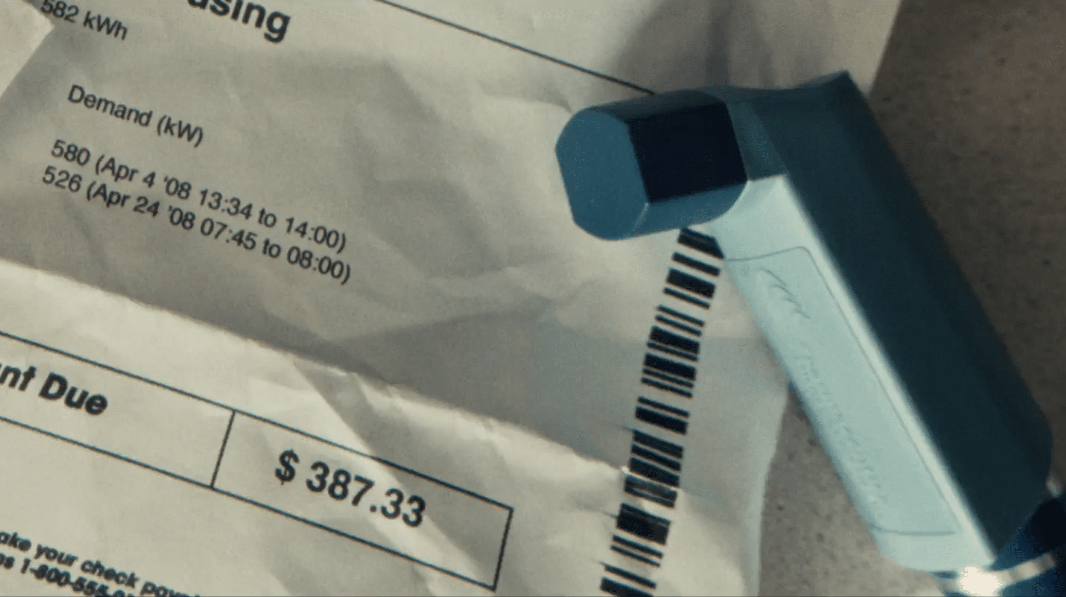 Photo of utility bill with inhaler on top of it